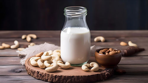 Cashew Milk in a bottle surrounded by cashews
